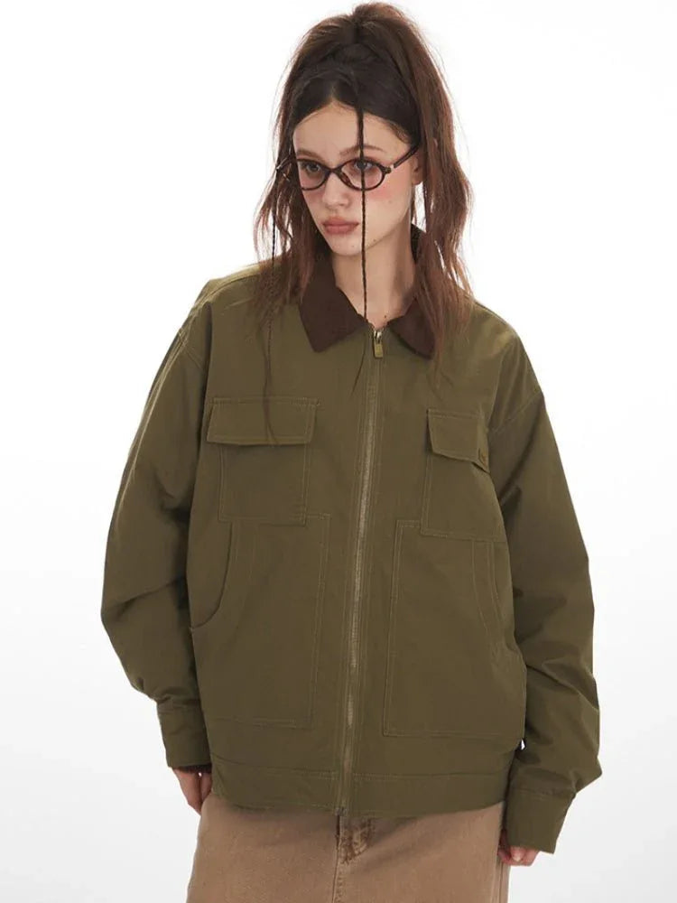 Close-up front view of a woman in an olive green jacket with a brown collar, showcasing pocket details.