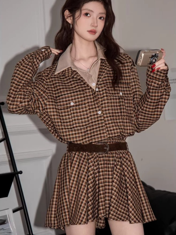 Woman posing with a camera while wearing the plaid shirt dress