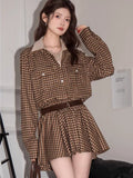 Full view of a woman in a brown plaid shirt dress