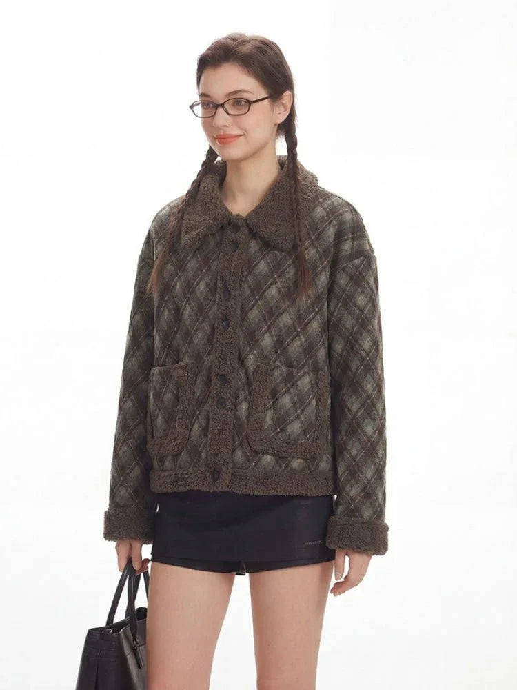 Close-up of a woman wearing a plaid bomber jacket with shearling collar and trim.