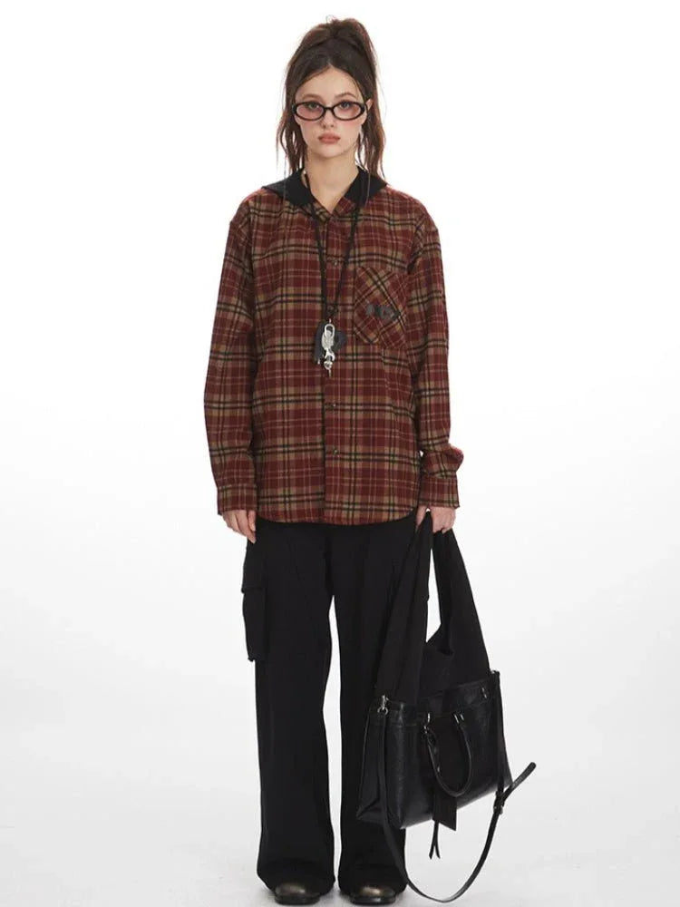 Woman wearing a red and tan plaid hooded flannel shirt with black cargo pants and a black handbag.