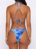 Back view of a blue floral print bikini with adjustable tie closures