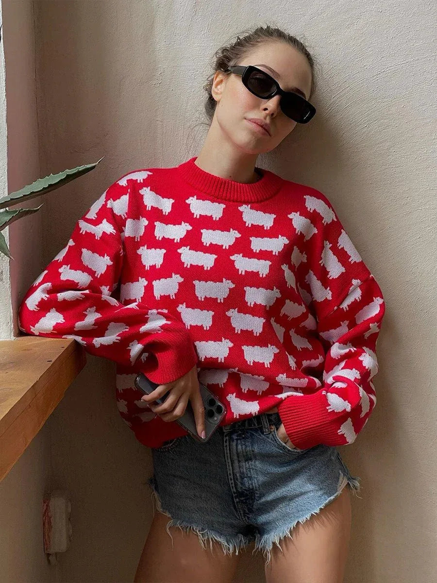 Woman wearing a red sweater with a white sheep pattern