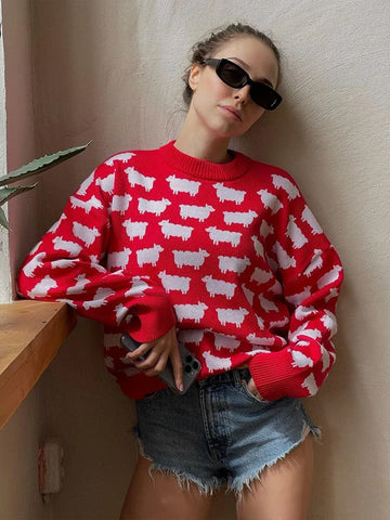 Woman wearing a red sweater with a white sheep pattern