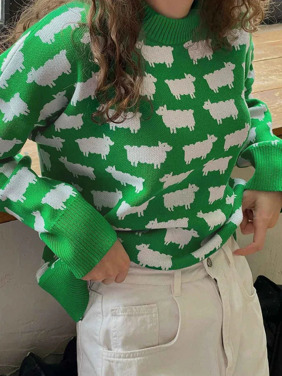 Woman wearing a green sweater with a white sheep pattern