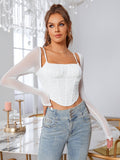 Woman with hand on hip wearing a white ruched bust corset top with sheer long sleeves