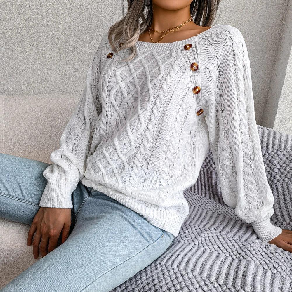 Woman in a white long-sleeve sweater with a boat neck and cable knit details, styled with denim.