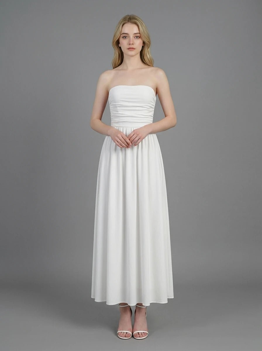 Woman wearing a white strapless ruched waist maxi dress, front view