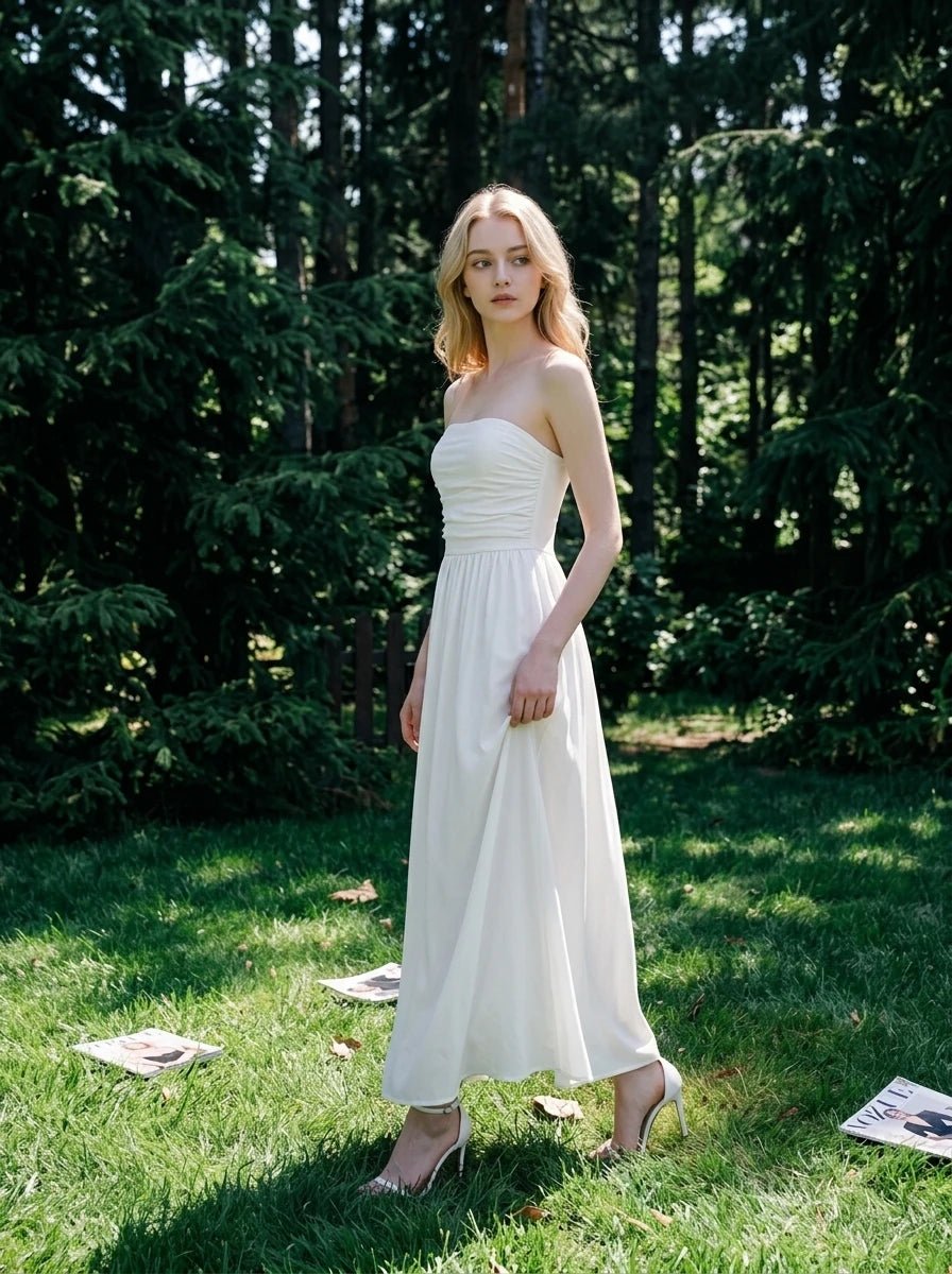 Woman wearing a white strapless ruched waist maxi dress standing in a forest
