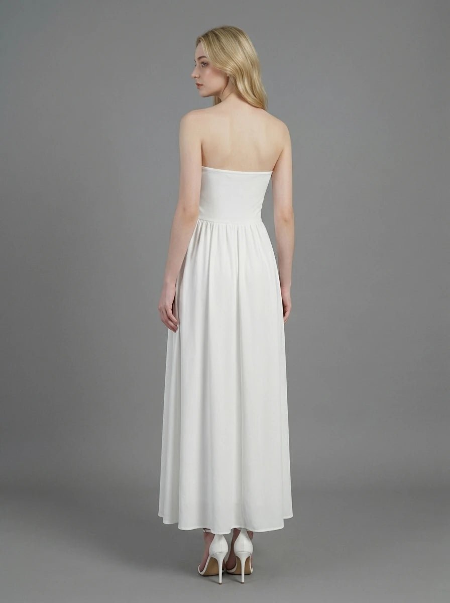 Woman wearing a white strapless ruched waist maxi dress, front view