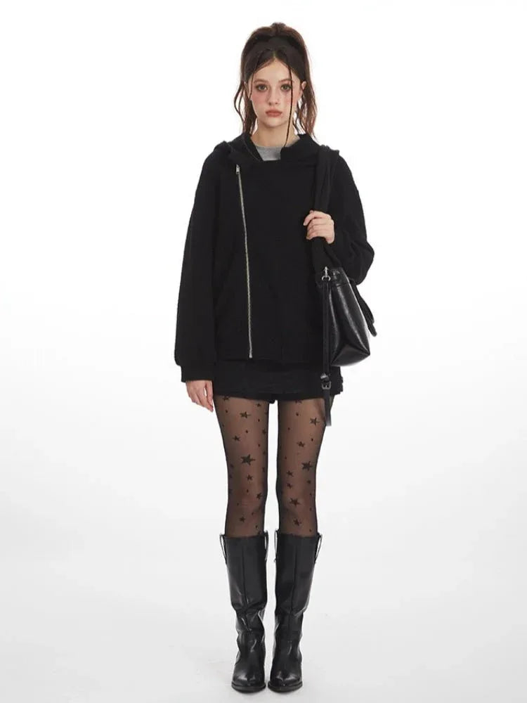 Woman wearing a black textured fleece hoodie with an asymmetrical zipper and hood. Main image