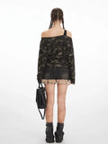 Back view of a woman wearing a camouflage print off-shoulder long sleeve top with a graphic print.