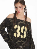 Detailed view of the graphic print on the camouflage off-shoulder top.