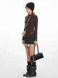 Side view of a model showcasing a brown long-sleeved top and a mini denim skirt with faux fur detail.